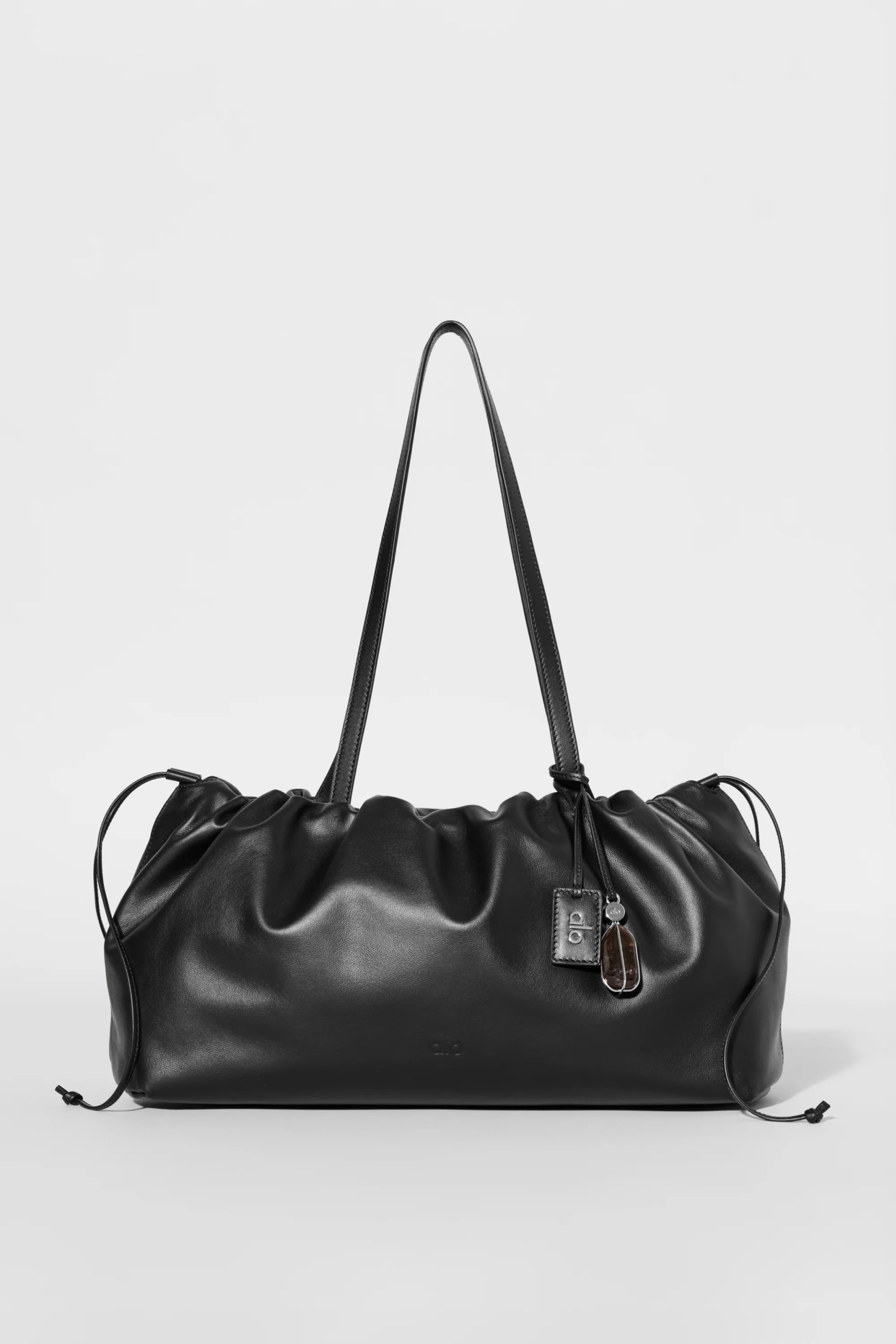 ALO Unwind Cinch Bag in Black Leather with Adjustable Drawstring