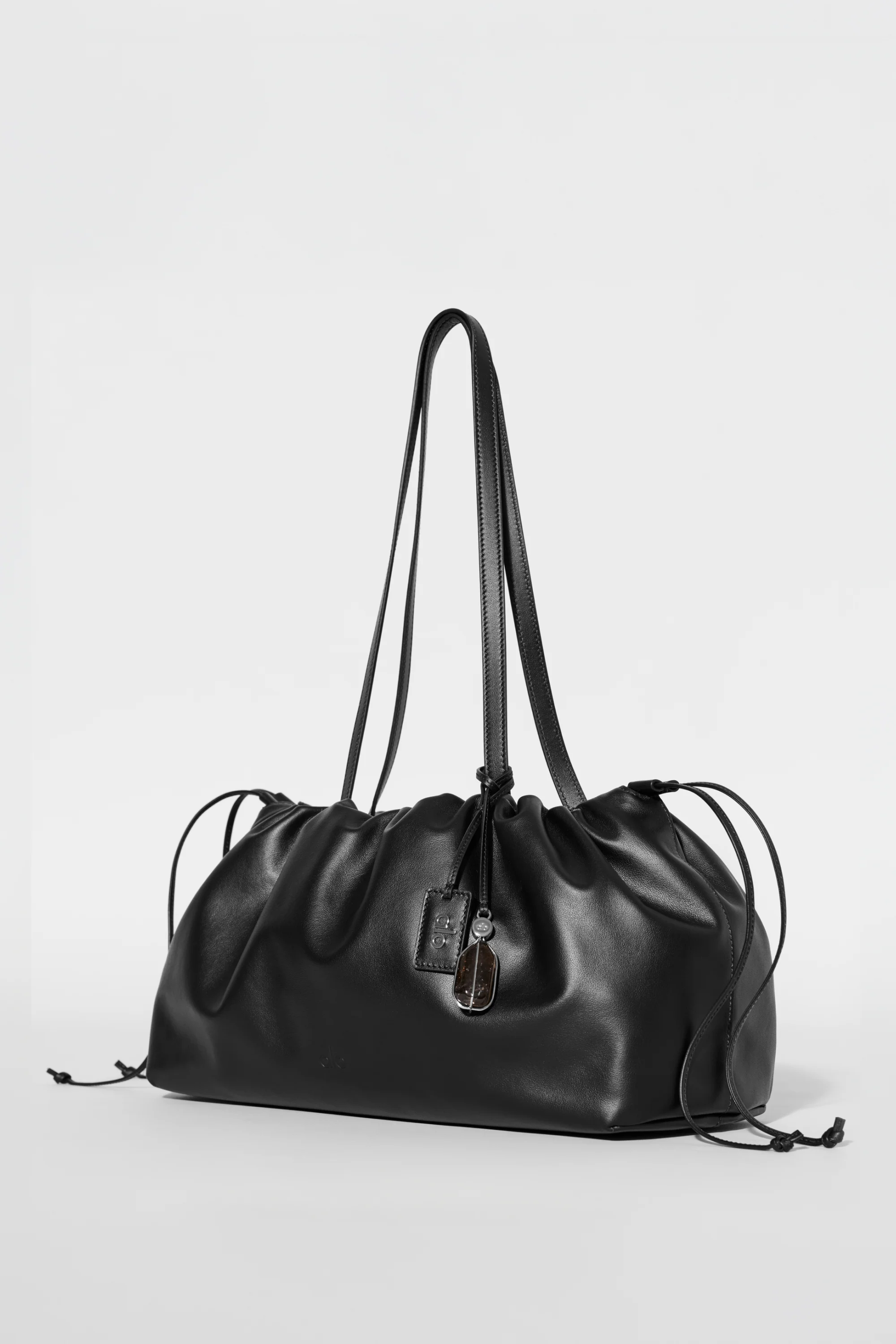 ALO Unwind Cinch Bag in Black Leather with Adjustable Drawstring