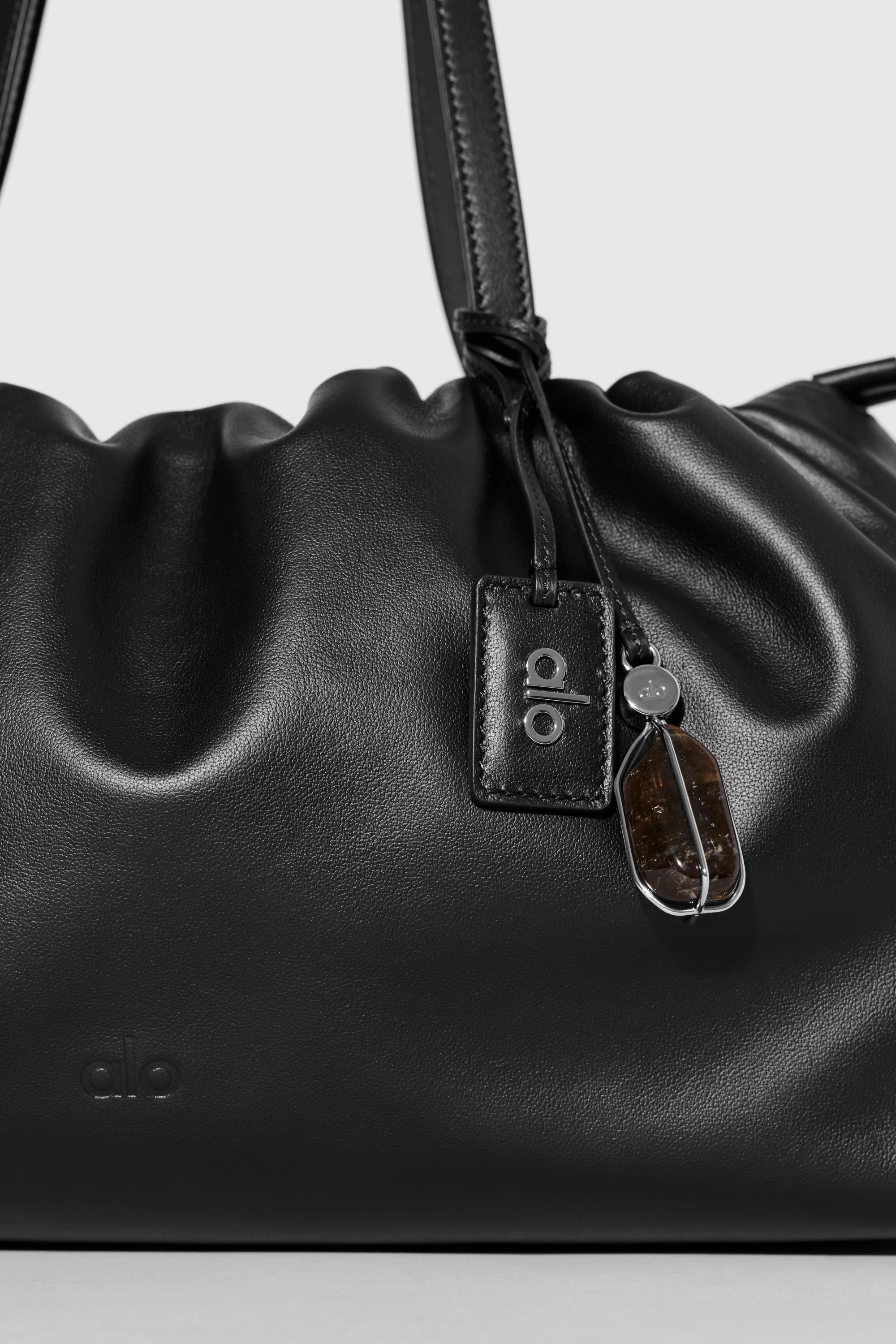ALO Unwind Cinch Bag in Black Leather with Adjustable Drawstring